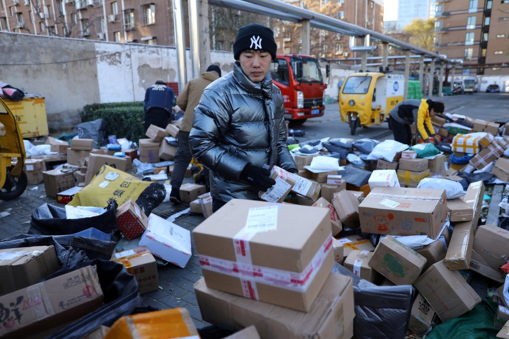 Delivery workers sort parcels at a makeshift logistics station near Beijing’s central business district during the Singles’ Day shopping festival on November 11. China’s dual circulation strategy aims to shift focus to domestic-driven growth, but the results of this may not be apparent in the short term. Photo: Reuters