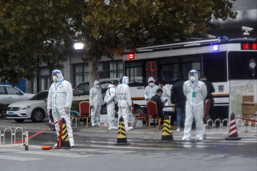 Epidemic prevention and control staff stand guard at an entrance to a residential neighbourhood under lockdown in Beijing in early October. Photo: EPA-EFE
