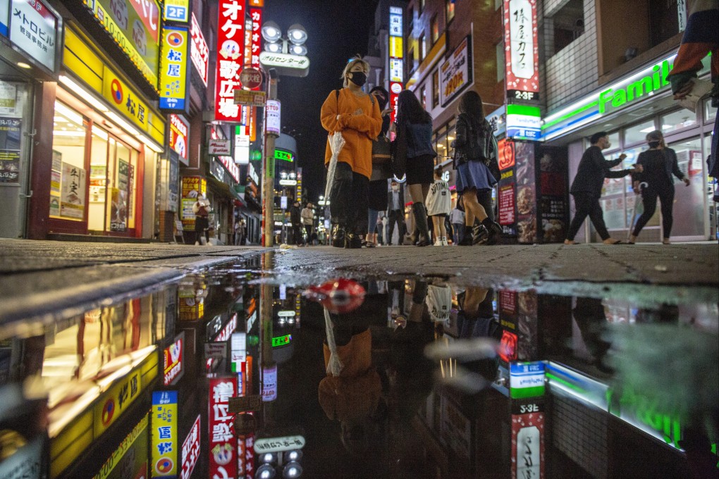 People walk along a street full of shops, bars and restaurants in Shibuya, Tokyo, on October 1. For investors to hold on to the yen in favour of the US dollar and other currencies, they will need to be persuaded that the economic outlook for Japan is better than for those other economies, and that’s a hard argument to make. Photo: AP