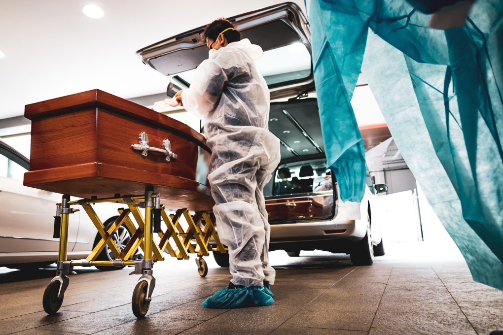 Funeral workers wear personal protective equipment before collecting a Covid-19 patient’s body. Photo: Marielle Descalsota
