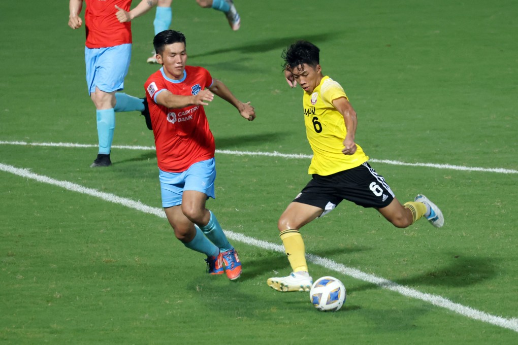 Lee Man’s Anson Wong Ho-chun (yellow shirt) in action against Athletic 220 FC’s Enkhzorig Khench-Yakhav at first half during the AFC Cup 2021 Group J match between Athletic 220 FC (MNG) vs Lee Man (HKG) at Tseung Kwan O Sports Ground.  29JUN21 SCMP / K. Y. Cheng