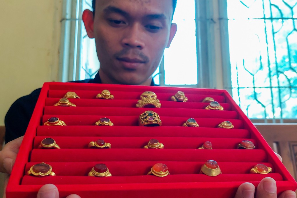 Diver and collector Asmadi shows off some items from his gold ring collection. Photo: Hafidz Trijatnika