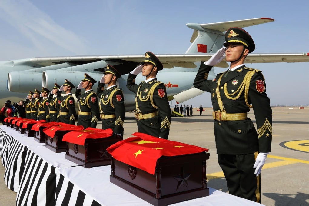 Chinese soldiers salute coffins containing the remains of Chinese military personnel who died during the 1950-53 Korean War, at Incheon International Airport in South Korea. Photo: EPA