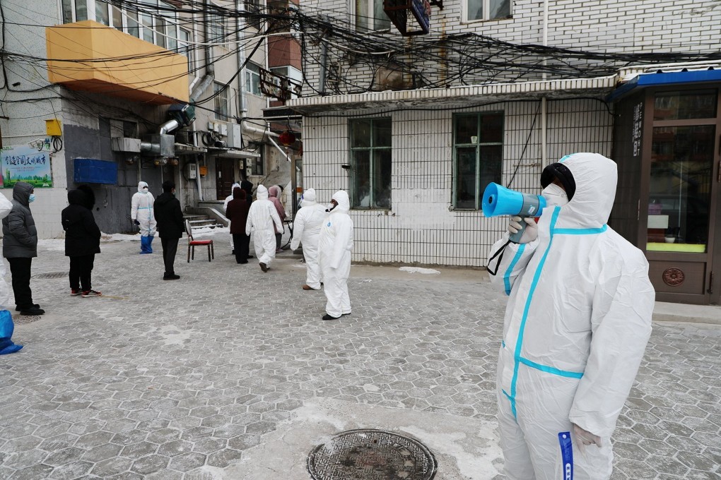 Officials direct residents during mass testing in Manzhouli, which is in the midst of an outbreak. Photo: Reuters