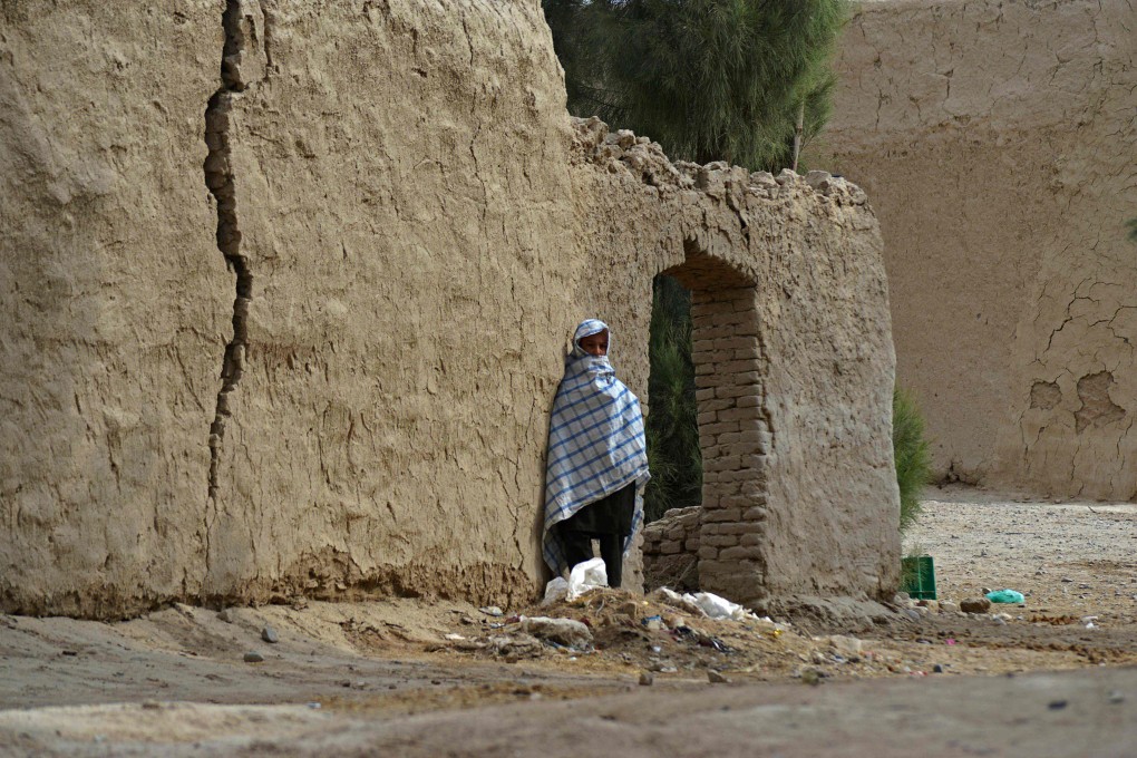 A child stands next to a wall near the birthplace of Taliban Supreme Leader Hibatullah Akhundzada at in Kandahar’s Panjwai district, Afghanistan. Photo: AFP