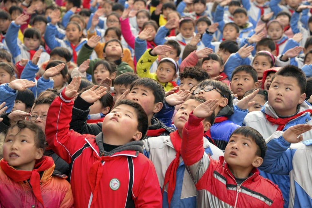 A primary school flag-raising ceremony. Pupils across the country will now face more classes designed to nurture a love for the party. Photo: Reuters