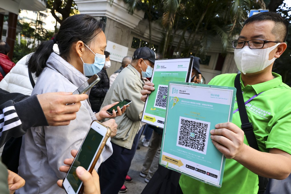 People use the Covid-19 coronavirus contact-tracing app “Leave Home Safe” outside Community Vaccination Centre in Jordan. Photo: Dickson Lee