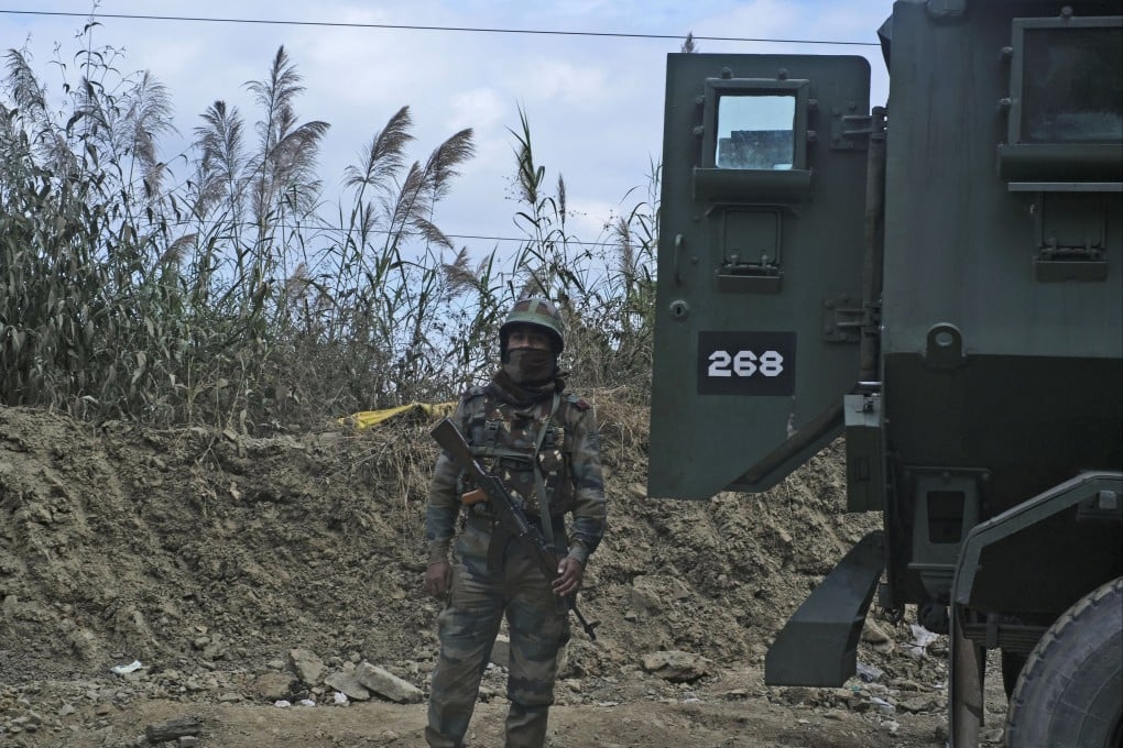 An Indian soldier stands guard on a highway on the outskirts of Kohima, Nagaland state, following protests by villagers after civilians were mistakenly killed by troops. Photo: AP
