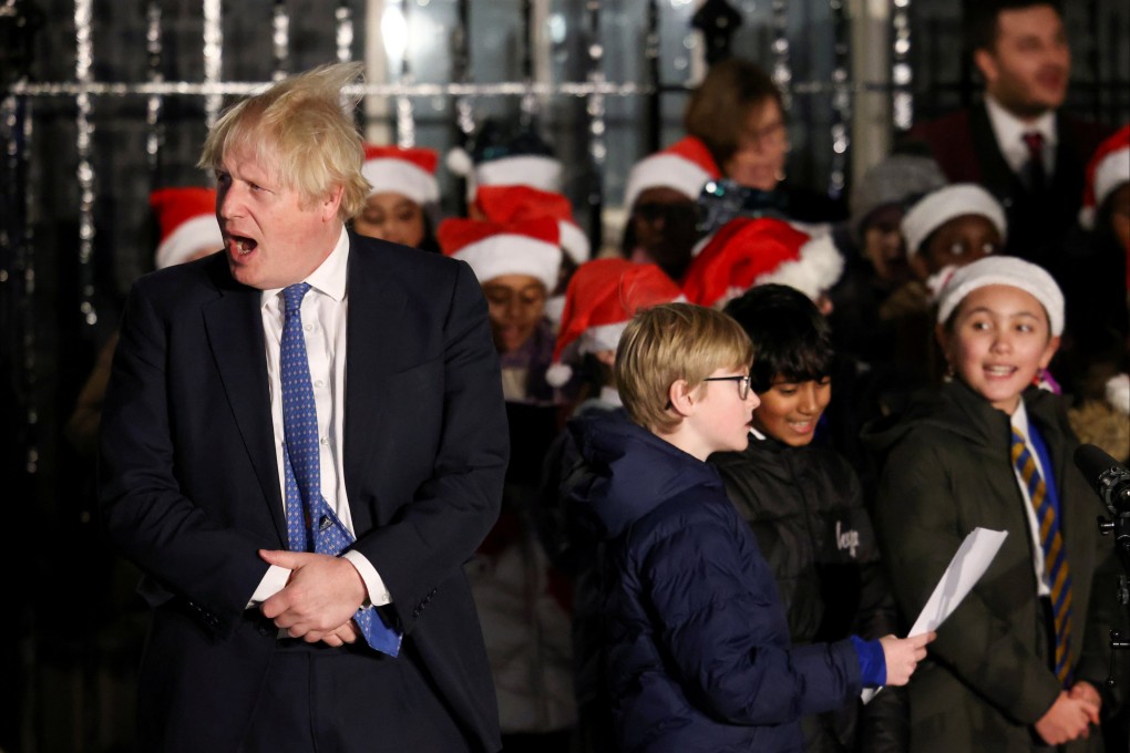 British Prime Minister Boris Johnson stands next to a children’s choir after switching on the Christmas tree lights in Downing Street, London on December 1. Photo: Reuters
