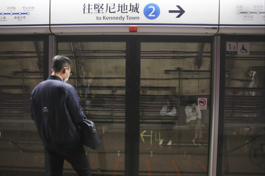 A billboard is removed from Causeway Bay station on December 3 after a board came off and hit a pair of train doors, which then fell off the train last week. Photo: Edmond So