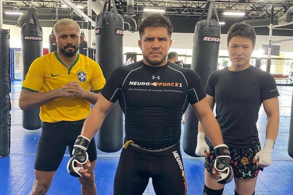 Henry Cejudo (centre) poses with Zhang Weili (right) and Deiveson Figueiredo at the Fight Ready gym in Scottsdale, Arizona. Photo: Instagram/Henry Cejudo