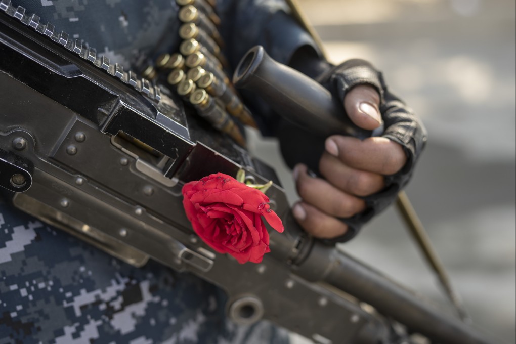 Taliban fighter with a rose on his machine gun. Photo: AP