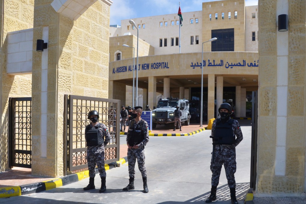 Police officers stand guard at the gate of the Salt government hospital in the city of Salt, Jordan on March 13. Photo: Reuters