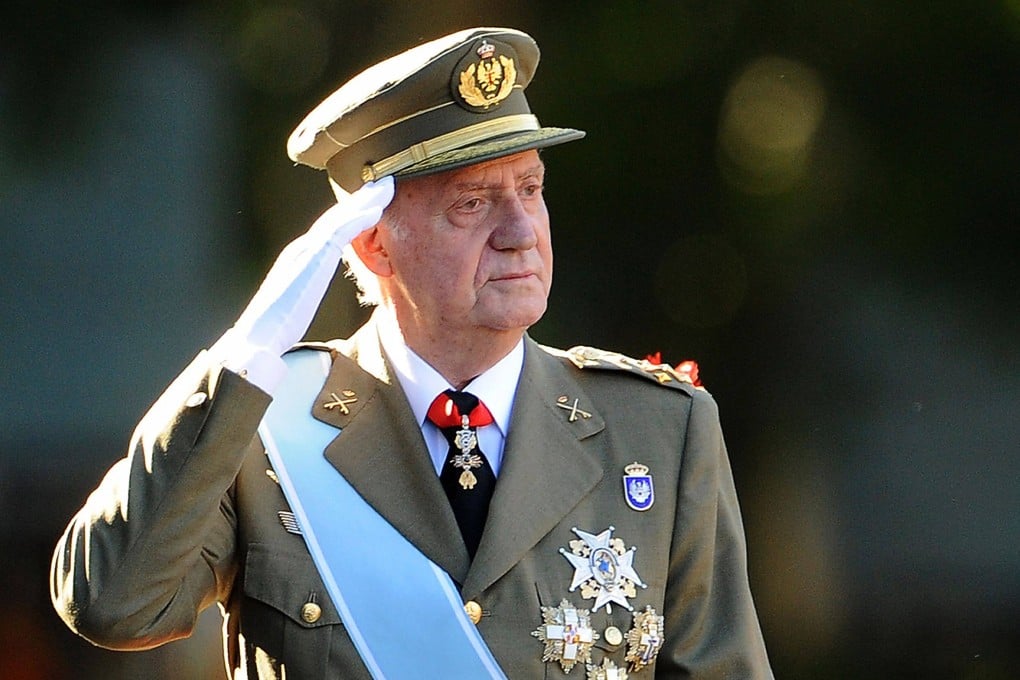 Then Spanish King Juan Carlos salutes the Royal Guard at a parade in Madrid in October 2011. Photo: AFP