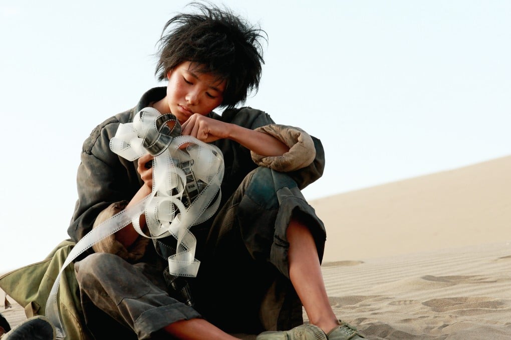 Liu Haocun in a still from One Second (category IIA, Mandarin), directed by Zhang Yimou. Zhang Yi co-stars.