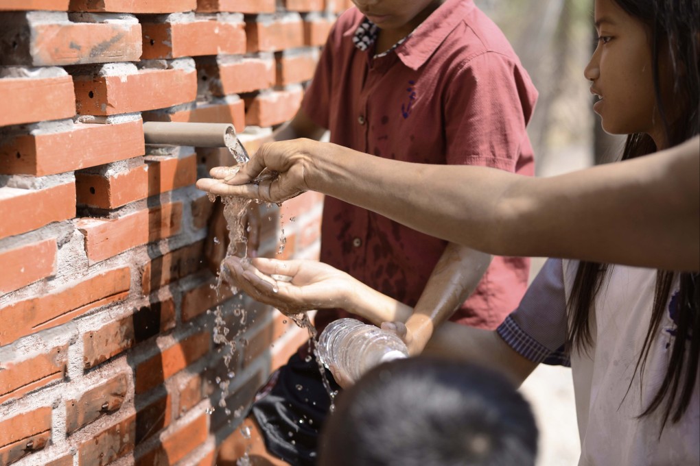 Locals from the Cambodian village of Sneung, on the outskirts of Battambang, collect clean water from WaterHall, designed by Hong Kong architects Magic Kwan and Kenrick Wong. The project won the pair the grand award for sustainability in this year’s DFA Awards.