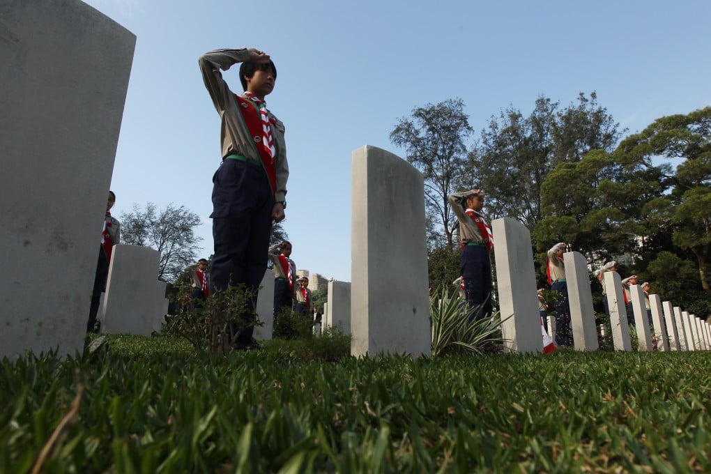 Boy scouts salute during a Canadian commemorative ceremony on the 70th anniversary of the Battle of Hong Kong, at Sai Wan War Cemetery in Chai Wan on December 4, 2011. In November 1941, two battalions from Canada arrived in Hong Kong to reinforce the local garrison. Photo: Sam Tsang