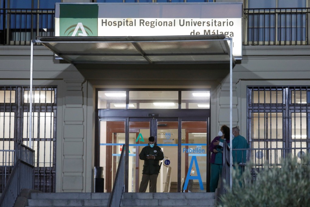 Health care workers stand at the front entrance of the University Regional Hospital in Malaga, southern Spain on Monday. Photo: Reuters