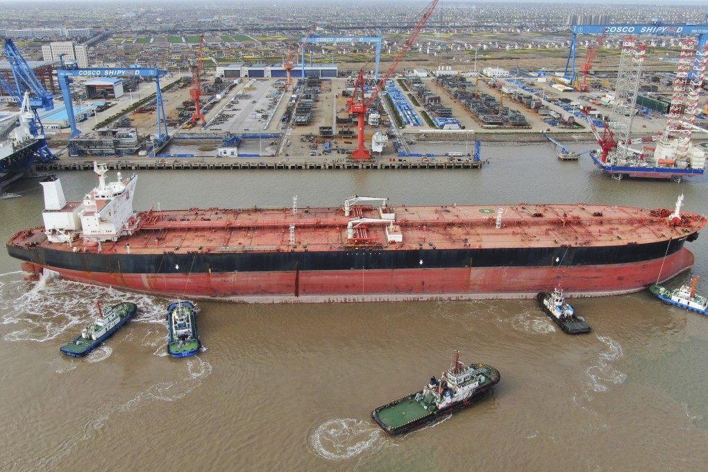 Tugboats nudging a 300,000-ton very large crude carrier (VLCC) to a shipyard on the Yangtze River for retrofitting in Qidong city in eastern China’s Jiangsu province on March 16, 2020. Photo: Chinatopix via AP.