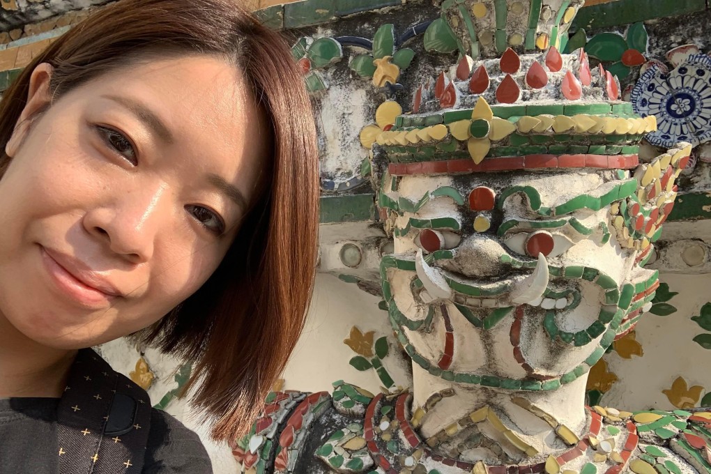 Shiori Kumagai from Japan at Wat Arun in Bangkok. Compared to her first visit nine years ago, attractions were empty - good for photo taking, she says. Kumagai is in Thailand to work remotely. Photo: Thomas Bird