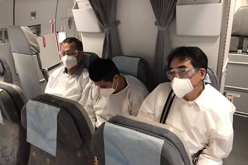 Taiwanese criminal investigation officers escort the suspect (centre) back to Taipei on Wednesday. Photo: AFP