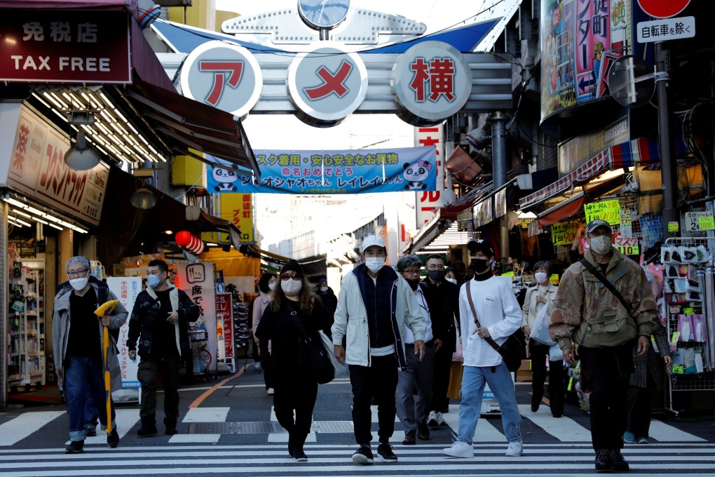 Pedestrians wearing protective face masks are seen walking in Tokyo. Photo: Reuters