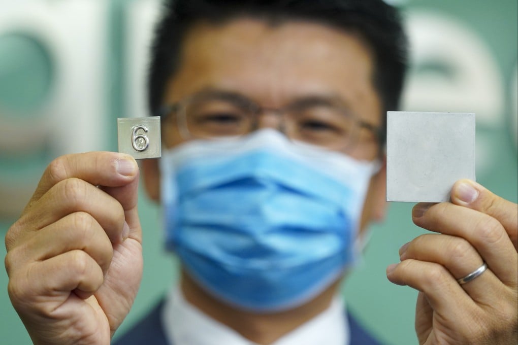 University of Hong Kong Professor Huang Mingxin displays a lift button and a sample piece made from a new stainless steel designed to kill coronavirus cells. Photo: Sam Tsang