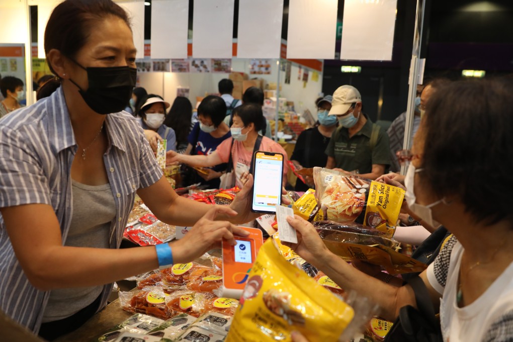 A woman uses an e-voucher, distributed as part of a government scheme to boost the economy, at the Hong Kong Brands and Products Shopping Expo at AsiaWorld-Expo on August 7. The e-vouchers gave many Hongkongers their first taste of e-payment. Photo: Winson Wong