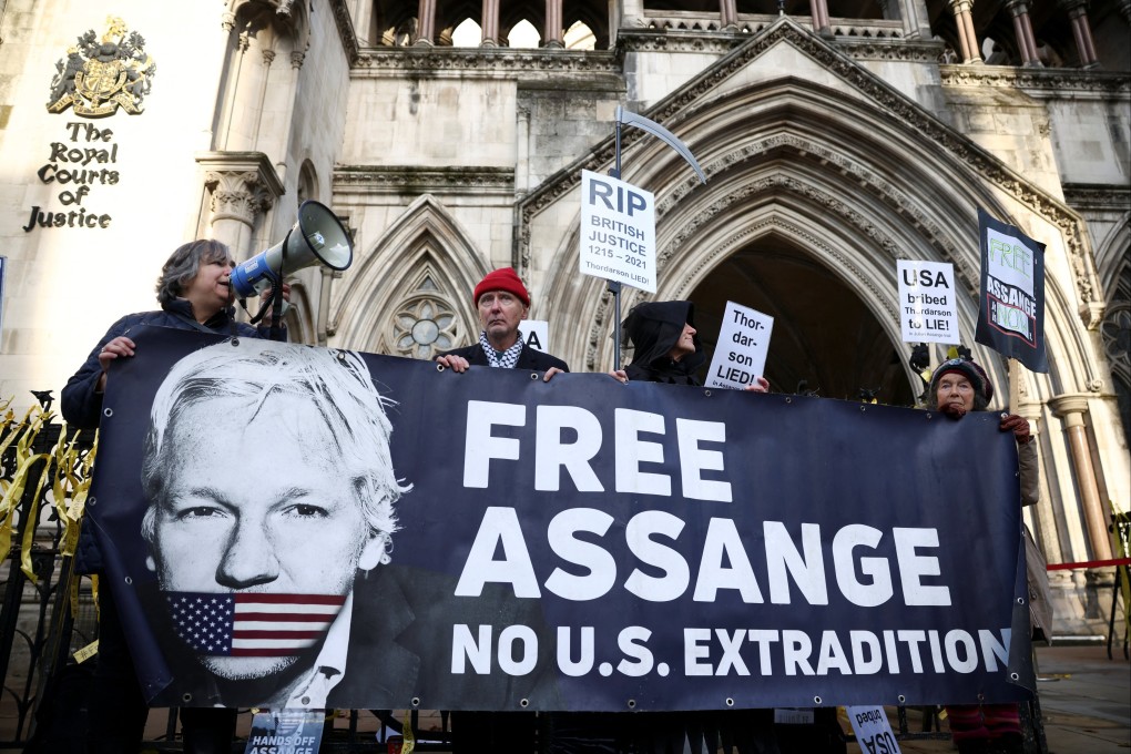 Supporters of Julian Assange hold a banner outside the Royal Courts of Justice in London. Photo: Reuters