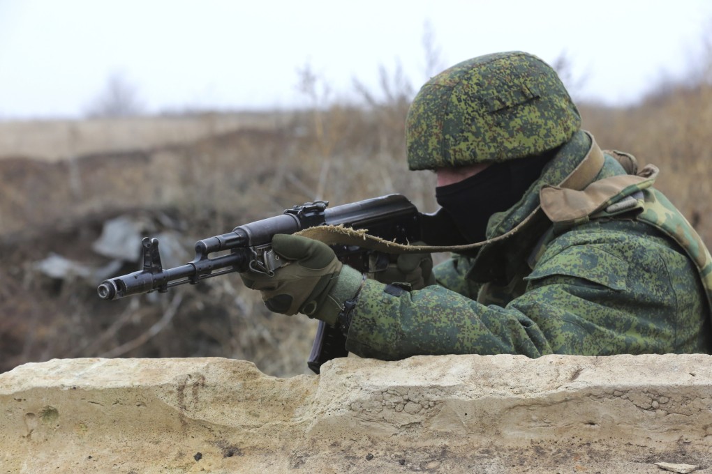 A serviceman holds his Kalashnikov rifle on Thursday as he guards at the line of separation near Sentianivka in Ukraine’s Luhansk region, controlled by Russia-backed separatists. Photo: AP