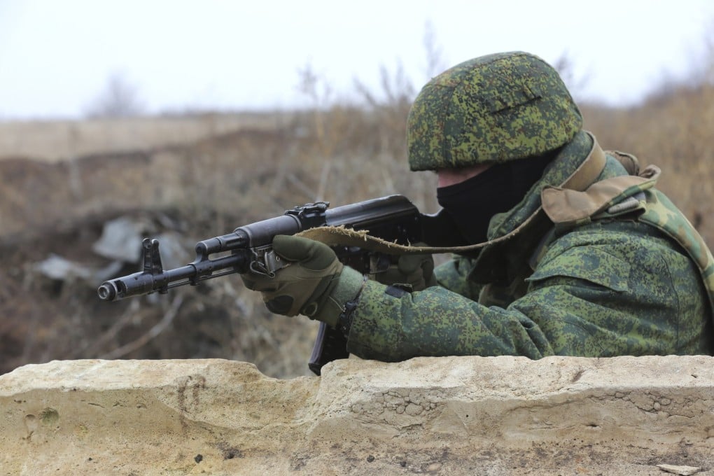 A serviceman holds his Kalashnikov rifle on Thursday as he guards at the line of separation near Sentianivka in Ukraine’s Luhansk region, controlled by Russia-backed separatists. Photo: AP