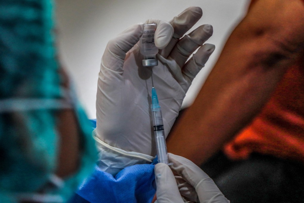 A health worker prepares to give a Covid-19 vaccine shot. Merriam-Webster and Oxford English Dictionary have chosen “vaccine” and “vax” as 2021’s words of the year. Photo: EPA-EFE
