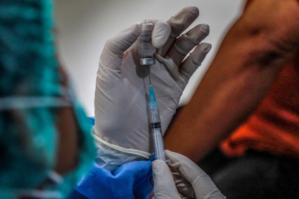 A health worker prepares to give a Covid-19 vaccine shot. Merriam-Webster and Oxford English Dictionary have chosen “vaccine” and “vax” as 2021’s words of the year. Photo: EPA-EFE