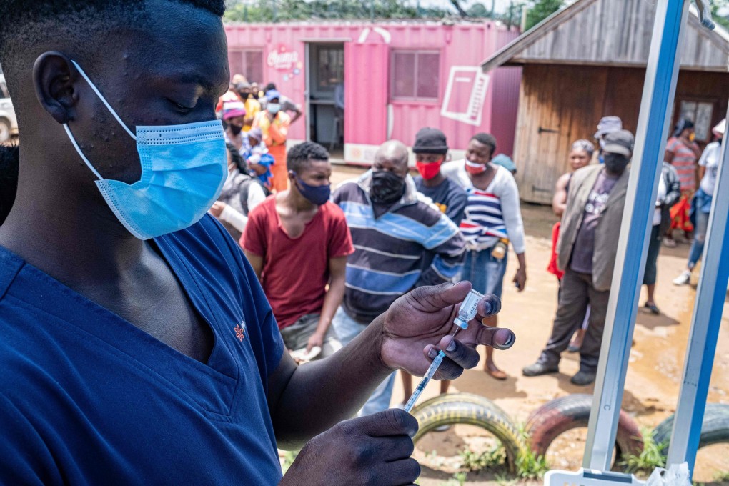 A health worker fills up a syringe with a dose of a Covid-19 vaccines as people queue at the Kya Sands informal settlement in Johannesburg on Wednesday. Photo: AFP