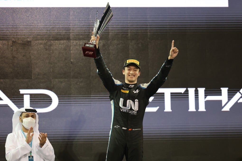 Zhou Guanyu celebrates on the podium after winning the sprint race 2 of the FIA Formula 2 Championship in Abu Dhabi. Photo: Xinhua
