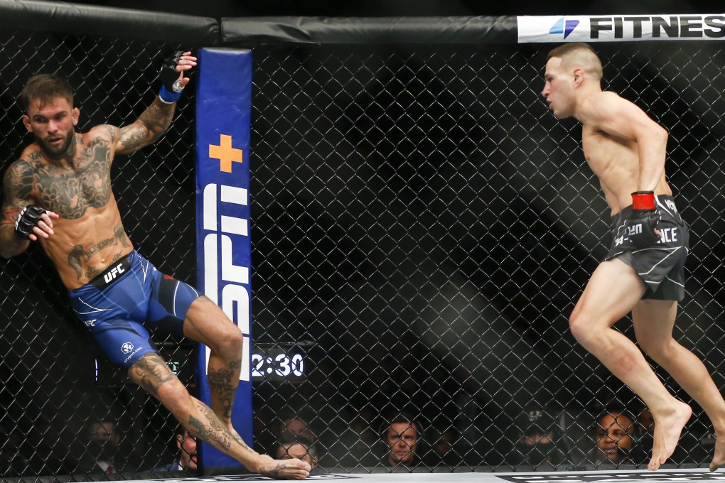 Cody Garbrandt gets knocked back by Kai Kara-France during their flyweight bout at UFC 269. Photo: AP/Chase Stevens