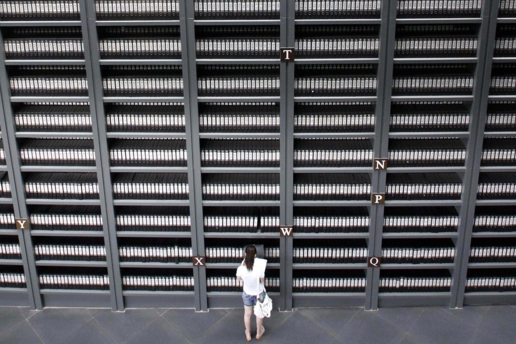 A girl reads files on victims killed during the Nanking massacre at a memorial Hall in Nanjing, Jiangsu province. Photo: AFP