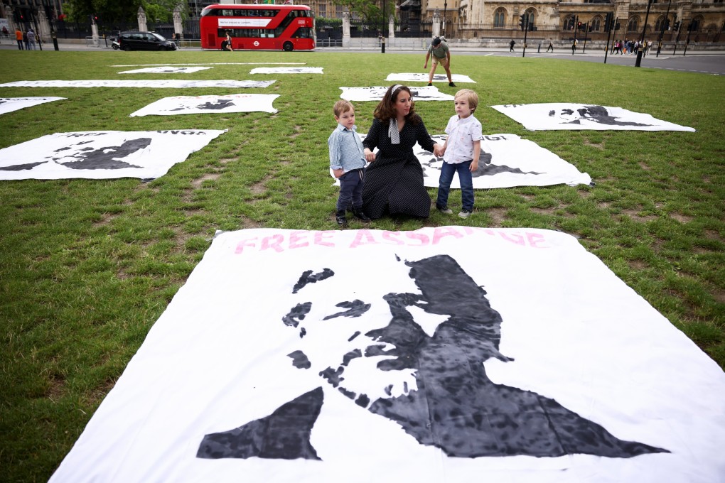 Stella Morris, partner of Wikileaks founder Julian Assange, joins a picnic protest with her children, Max and Gabriel, to mark Assange’s 50th Birthday, in Parliament Square, London. Photo: Reuters