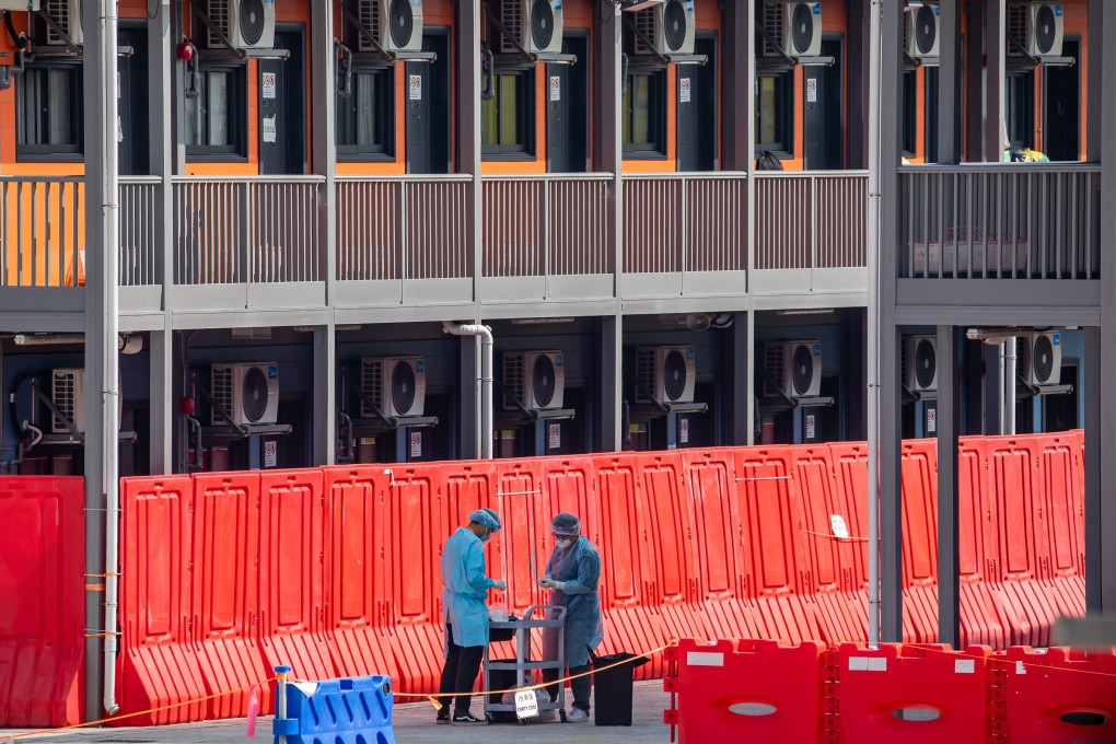 Staff members outside quarantine rooms at the Hong Kong government’s facility in Penny’s Bay, now a holding area for arrivals from countries with Omicron risks. Photo: Bloomberg