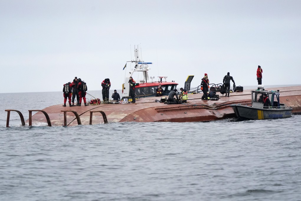 Divers work on the capsized Danish cargo ship Karin Hoj after it collided with British cargo vessel Scot Carrier in the Baltic Sea on Monday. Photo: AP