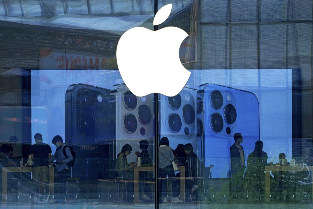 In this Sept. 28, 2021 file photo, people try out the latest iPhone 13 handsets at an Apple Store in Beijing. Photo: AP