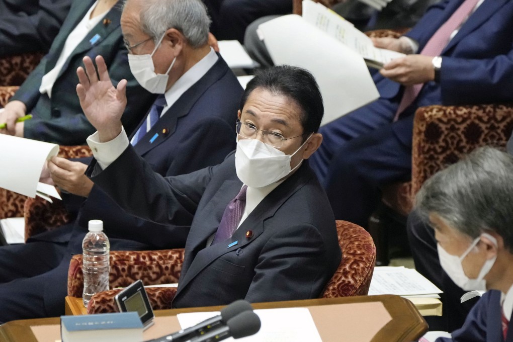 Japanese Prime Minister Fumio Kishida raises his hand to speak during a House of Representatives Budget Committee session in Tokyo on December 15. Photo: Kyodo