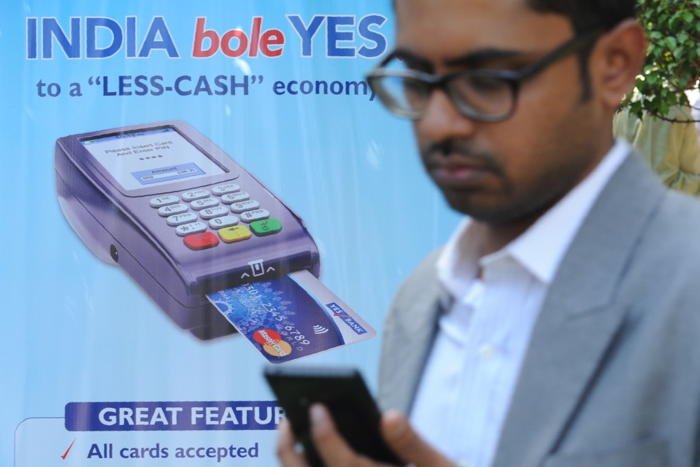 A man walks past a poster advertising electronic payments in Mumbai. File photo: AFP