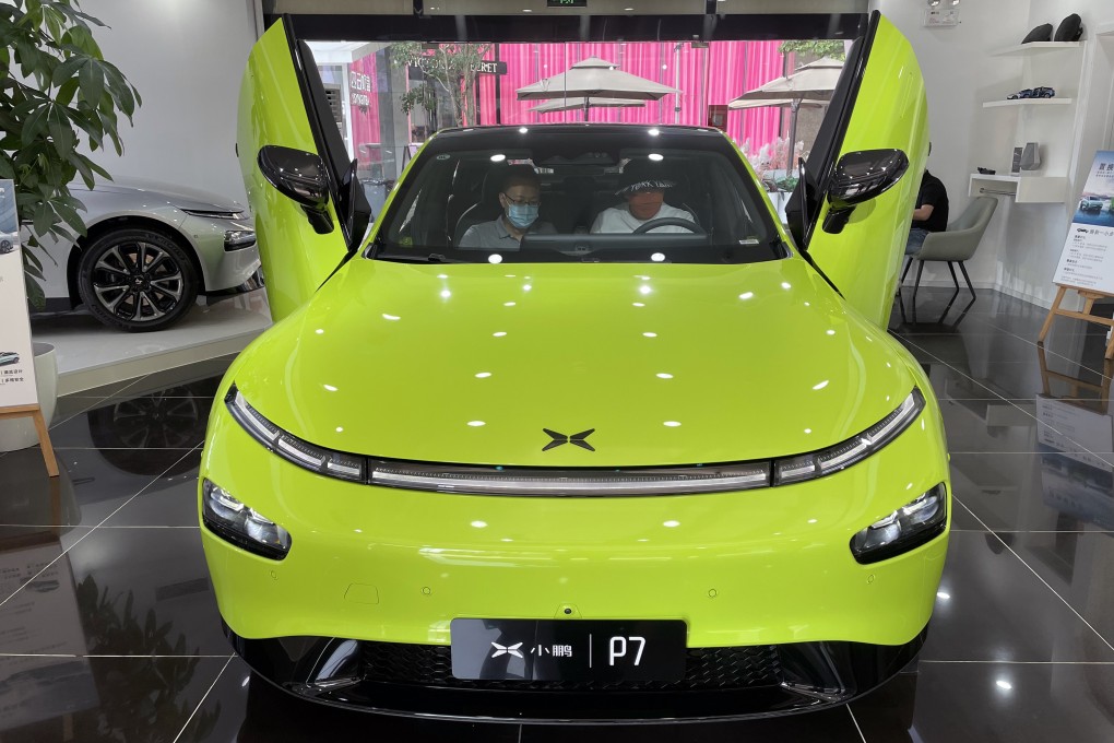 Two consumers check out an Xpeng P7 intelligent electric car at the company’s showroom in Beijing. Photo: Simon Song