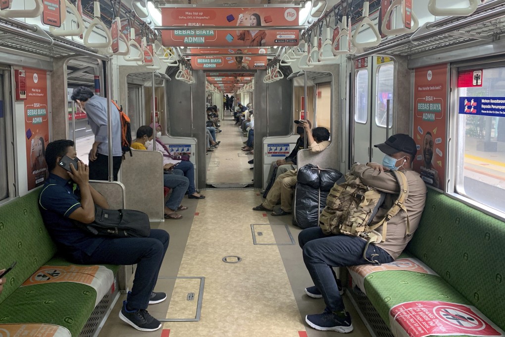 Train passengers social distancing in Jakarta, Indonesia, as country detected  first case of Omicron variant. Photo: AP