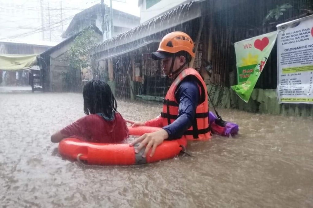 A member of the Philippine Coast Guard conducts a rescue operation during flooding caused by super typhoon Rai in Cagayan de Oro, southern Philippines. Photo: EPA-EFE