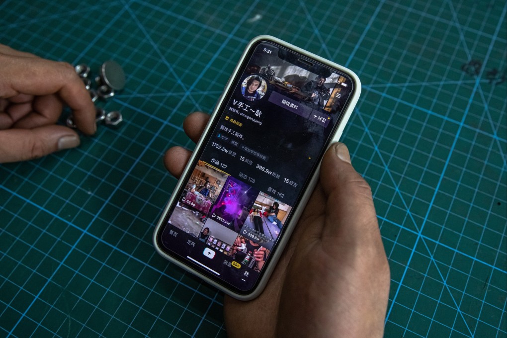 Geng Shuai, a former factory worker who became an influencer, shows his Douyin profile with almost 4 million fans, at his workshop in Baoding city, Hebei province, China, 15 August 2020. Photo: EPA-EFE
