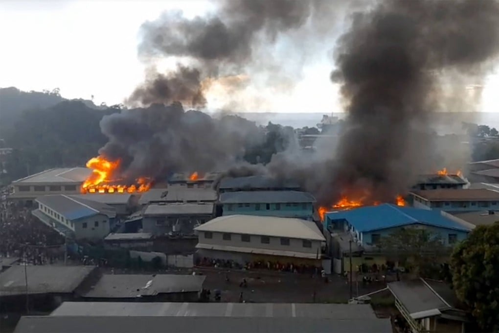 Parts of the Chinatown district in Honiara were ablaze after rioters torched buildings in the Solomon Islands capital on November 25 during anti-government protests. Photo: AFP