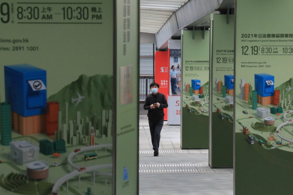 A man walks through posters promoting Legislative Council polls in Admiralty on November 23. Photo: Felix Wong