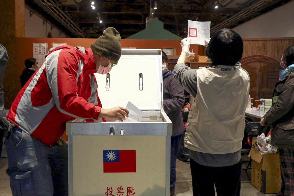 Electoral workers count votes for the four-question referendum in Taipei. Photo: Reuters